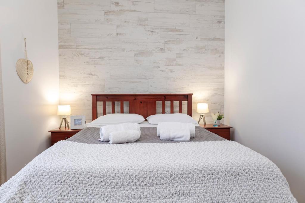 a bedroom with a large bed with two white pillows at Casa Borda da Rocha in Nordeste