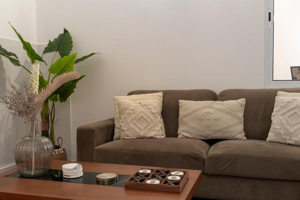 a living room with a brown couch and a table at Casa Borda da Rocha in Nordeste
