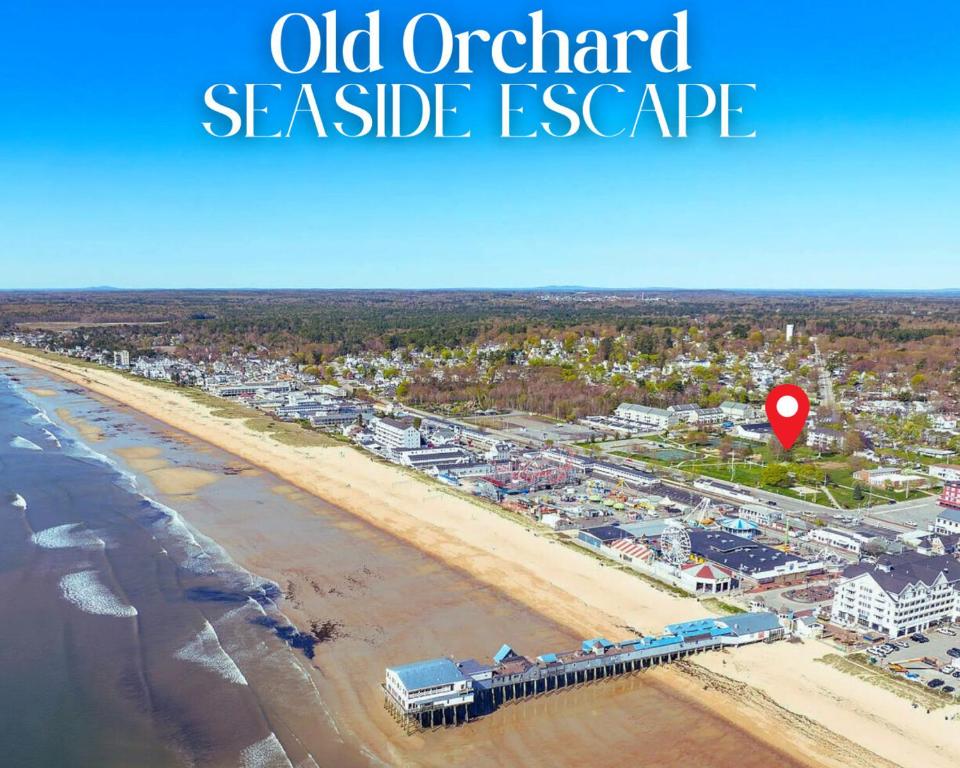 an aerial view of a sandy beach with a red marker at 2 Beachfront Condos Sunset Suites 4 and 5 in Old Orchard Beach