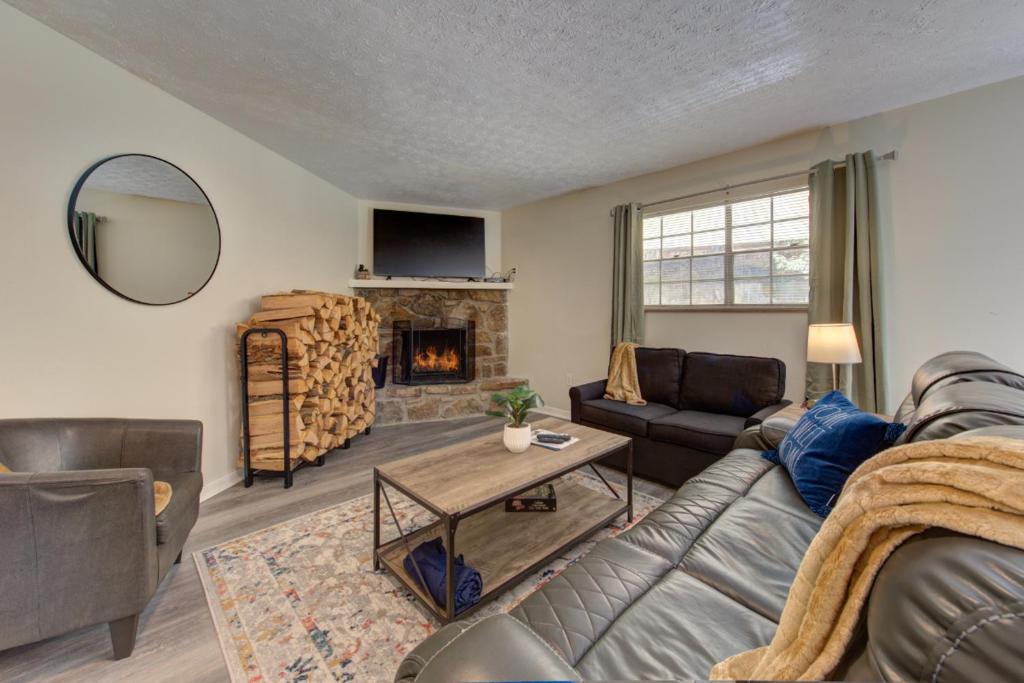 a living room with a couch and a fireplace at Roaring Fork Road Retreat By Avada Properties in Gatlinburg
