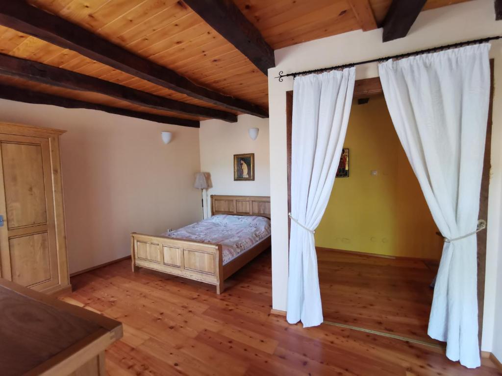 a bedroom with a bed and curtains in a room at Domus Carstica in Sežana