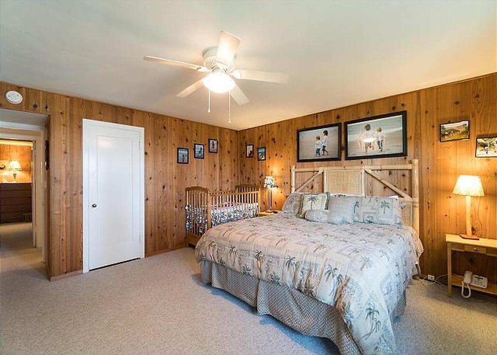 a bedroom with a bed and a ceiling fan at Surfers Cove in Seaside