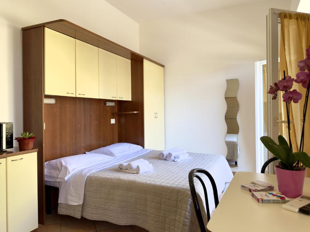 a bedroom with a bed with towels on it at Residence Carioca in Rimini