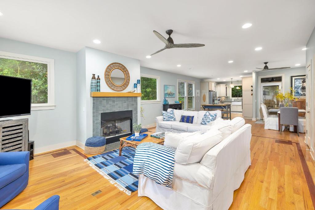 a living room with a white couch and a fireplace at 1104 Demere Road in Saint Simons Island