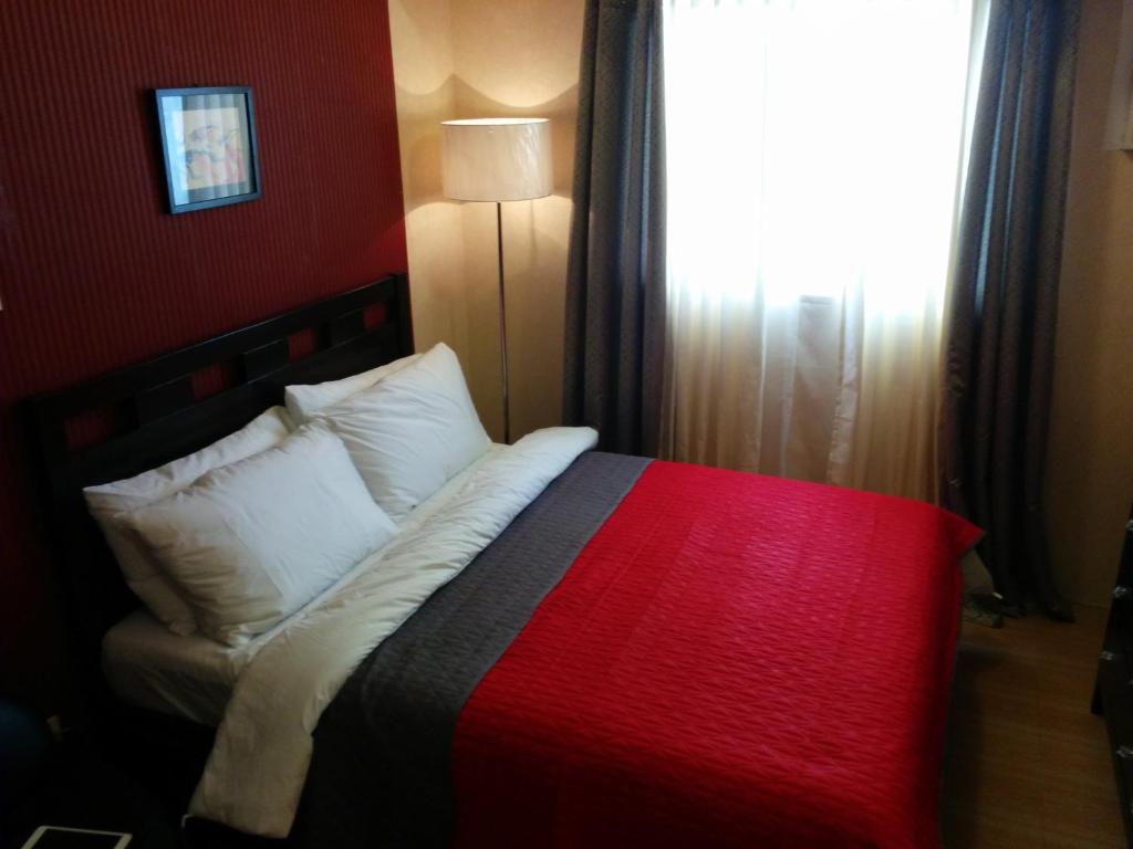 Ένα ή περισσότερα κρεβάτια σε δωμάτιο στο Sodi's Place at Escalades Condominium