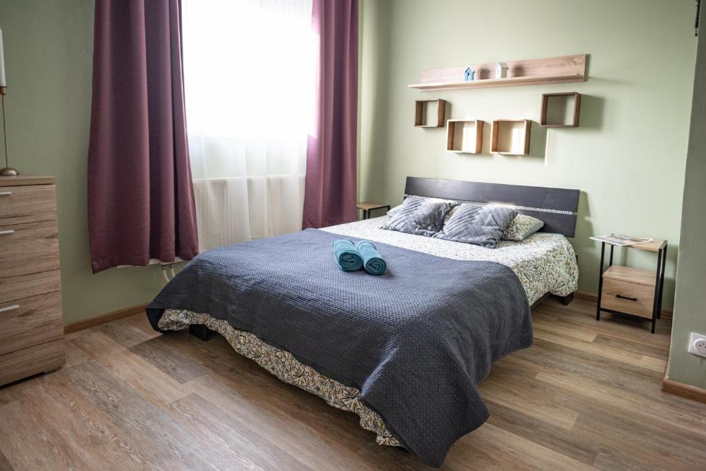 a bedroom with a bed with blue shoes on it at Fanta flat France Suisse in Saint-Louis