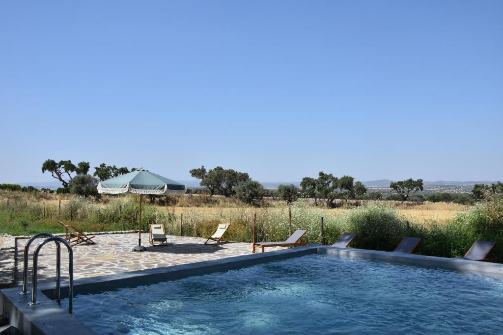 a swimming pool with a view of a field at Herdade Joana Dias by PortusAlacer in Arronches
