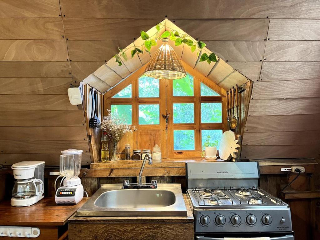 a kitchen with a sink and a window at Beautiful Cabin in Casa Papagayo, San Marcos, Atitlán in San Marcos La Laguna
