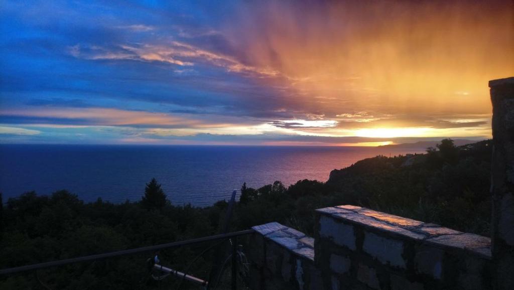 a view of the ocean at sunset from a house at Rezevici AZUR in Budva