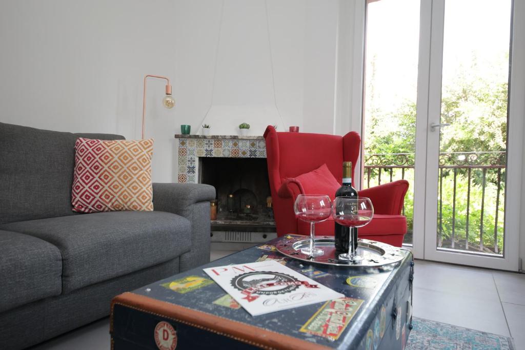 a living room with a couch and a table with wine glasses at Il Cortiletto - Cozy Apt Brand New Equipped Private Garden - BBQ in Como
