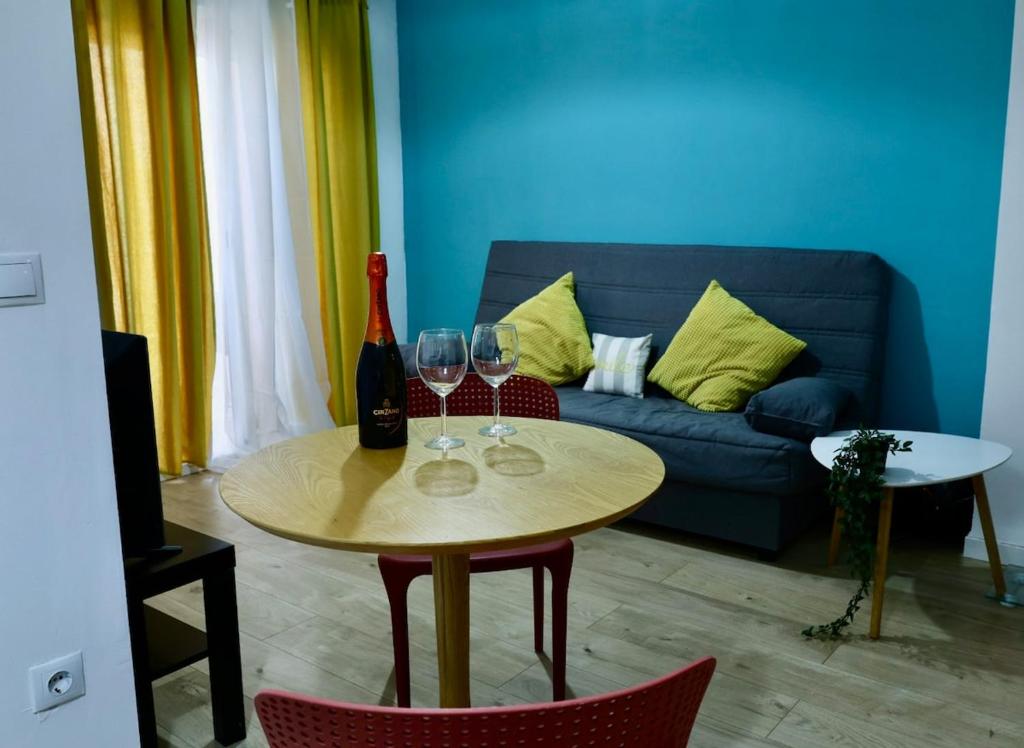 a living room with a table and two wine glasses at Cozy Seaside Apartment in Cullera in Cullera