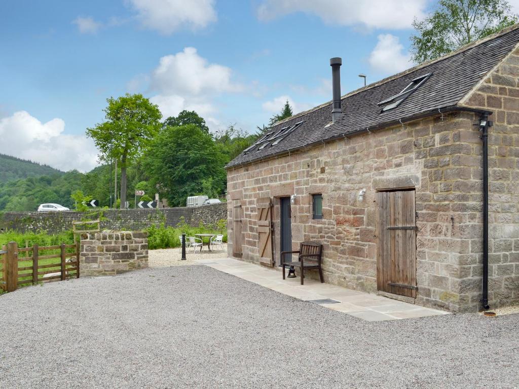 an old stone building with a wooden door at Fishermans Lodge in Highpeak Junction