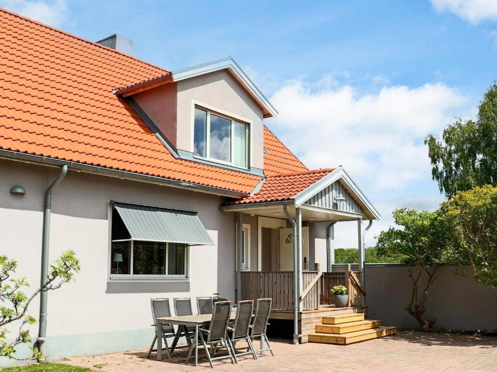 una imagen de una casa con techo naranja en 4 star holiday home in Förslöv, en Förslöv
