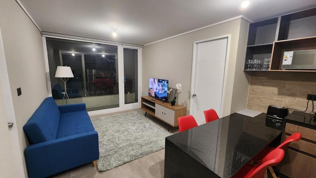 een woonkamer met een blauwe bank en een tafel bij Inmejorable ubicación 2D2B, con estacionamiento in Los Ángeles