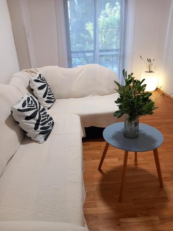 a living room with a white couch and a table at Maris in Banjole