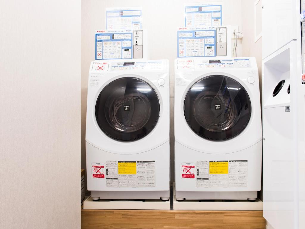 two washing machines sitting next to each other at Meitetsu Inn Hamamatsucho in Tokyo
