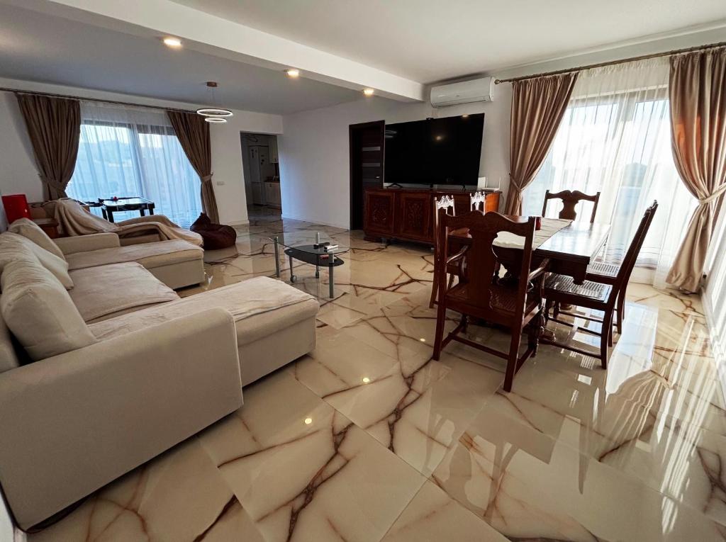 a living room with a couch and a table at Casa Stefan in Sînmartin