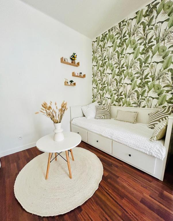 a living room with a couch and a table at Nice studio with a terrace in Levallois-Perret