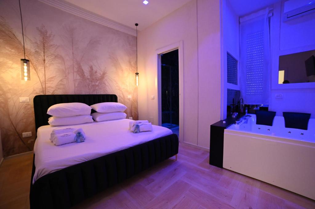 a bedroom with a bed with white sheets and pillows at Gran Duca Santo Stefano Suite ZONA CASALE VICINO AEROPORTO in Brindisi