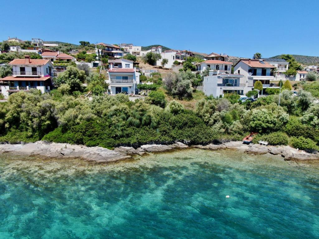 an aerial view of a beach with houses and water at Sea front condo on the Gulf of Pagasitikos in Marathos