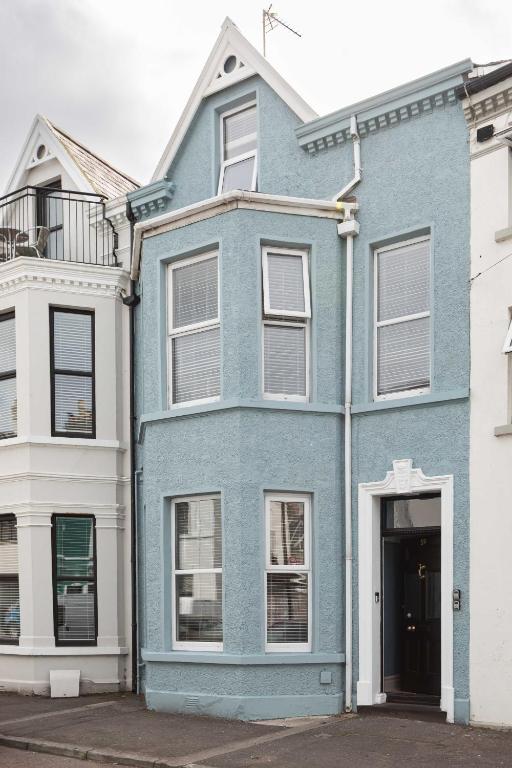 a blue house with a white at 1BR/3BR Apartments in Bangor - Mins to Seafront & High St. in Bangor