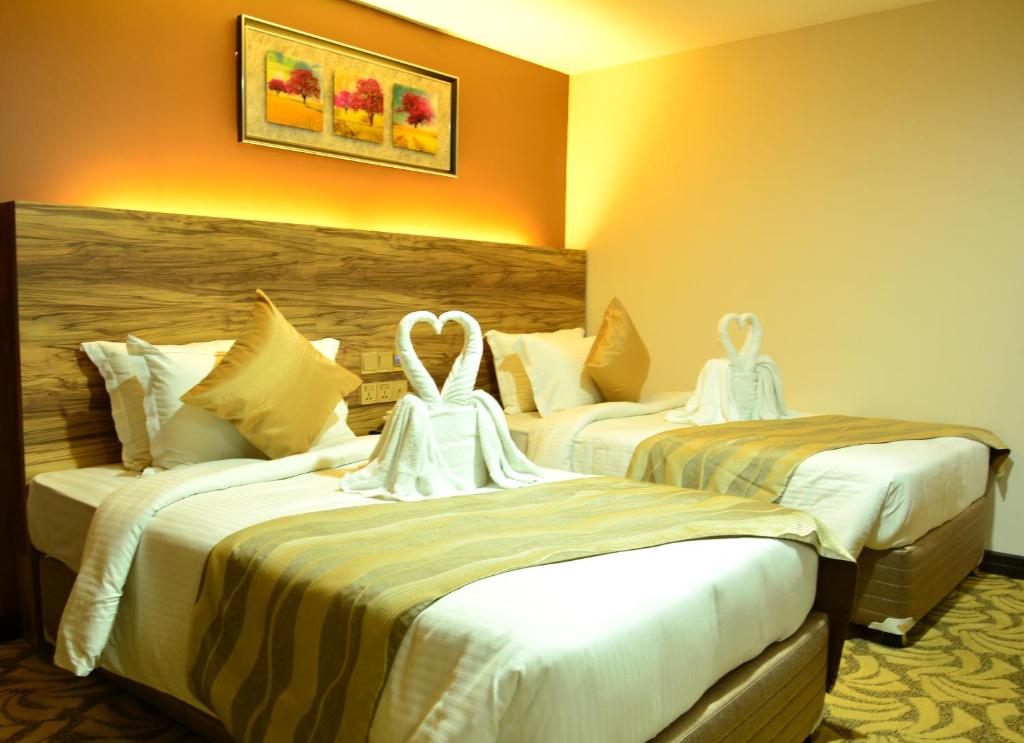 Postel nebo postele na pokoji v ubytování Pearl City Hotel