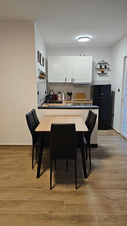 a kitchen with a table and chairs in a room at Val Center in Novalja