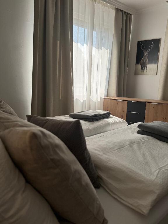 a bedroom with two beds and a window at ZwoLu Apartments in Bornheim