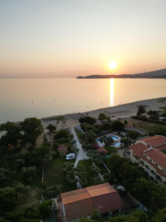 an aerial view of a resort and the ocean at sunset at Sissy's Suites San Antonio Beach Potos Thassos in Potos