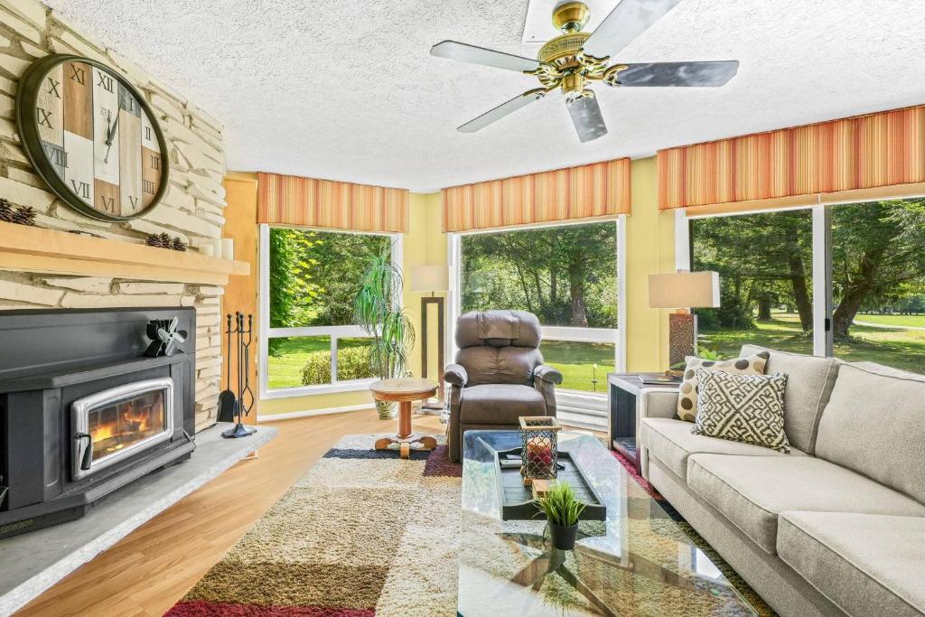 a living room with a couch and a fireplace at Fairway Forest Retreat! in Welches