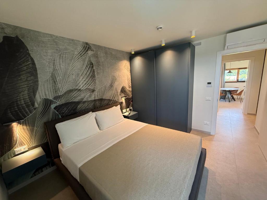 a bedroom with a bed and a painting on the wall at Suite Apartments Prestige in Bellaria-Igea Marina