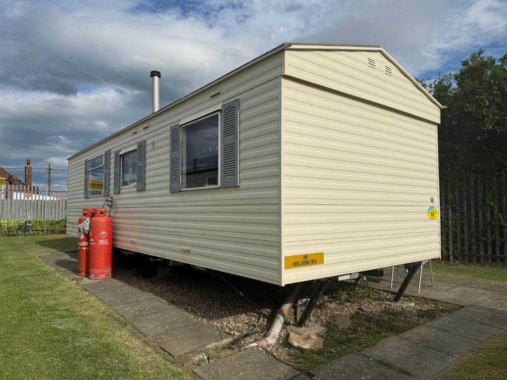 a tiny house is parked next to a fire hydrant at N&L Caravan Hire, The Highbury Caravan Park in Ingoldmells