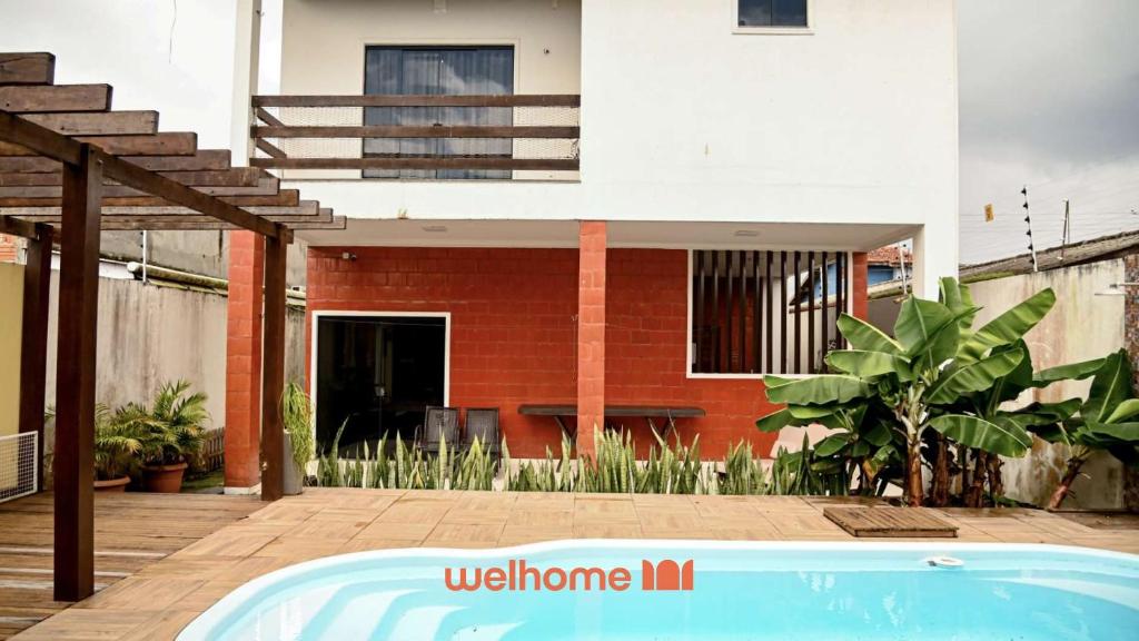a house with a swimming pool in front of a house at Casa em Macapa com Piscina e Academia Própria in Macapá