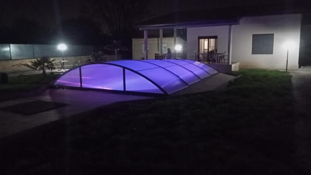 a lit up object in front of a house at night at Finca las palmeras 
