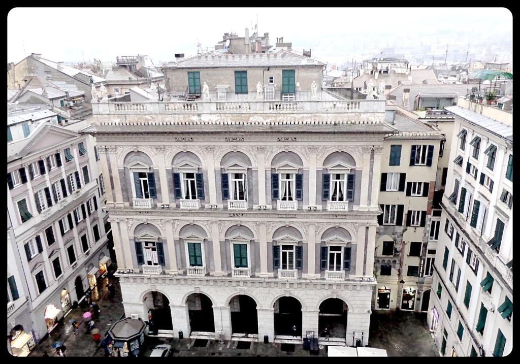 a large white building in the middle of a city at Residenza Bendinelli-Sauli in Genoa