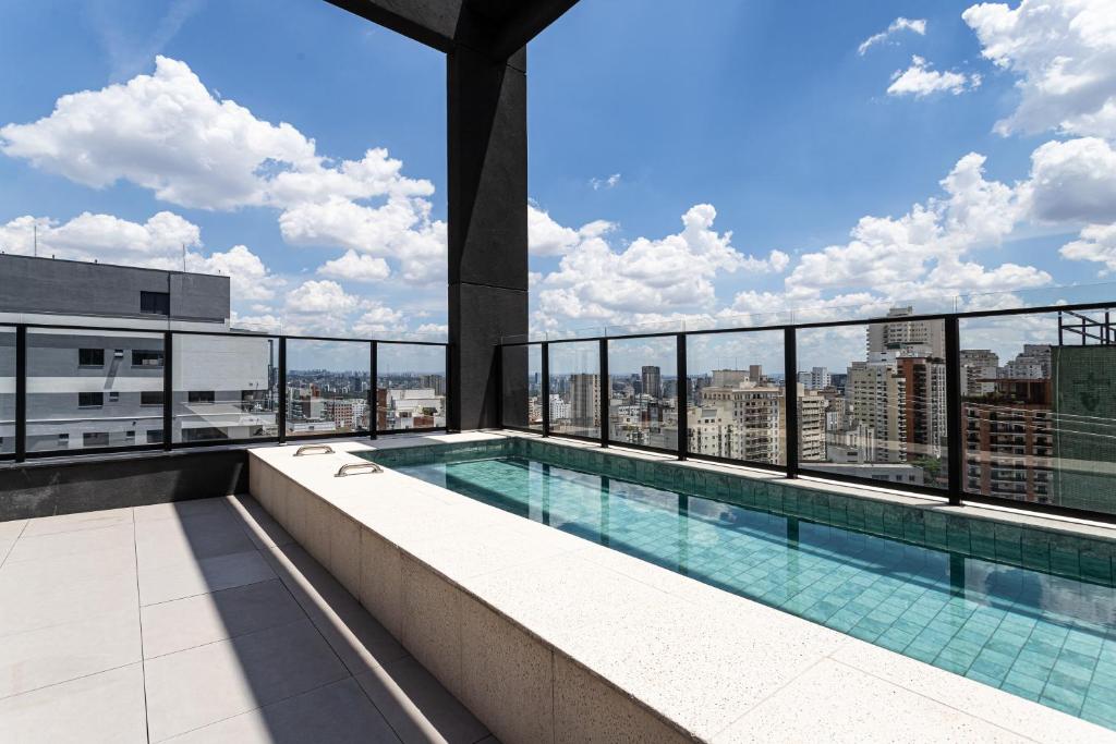 a swimming pool on the roof of a building at Pivô Pamplona by Viva - Apartamentos novos e espaçosos ao lado da Av Paulista in Sao Paulo