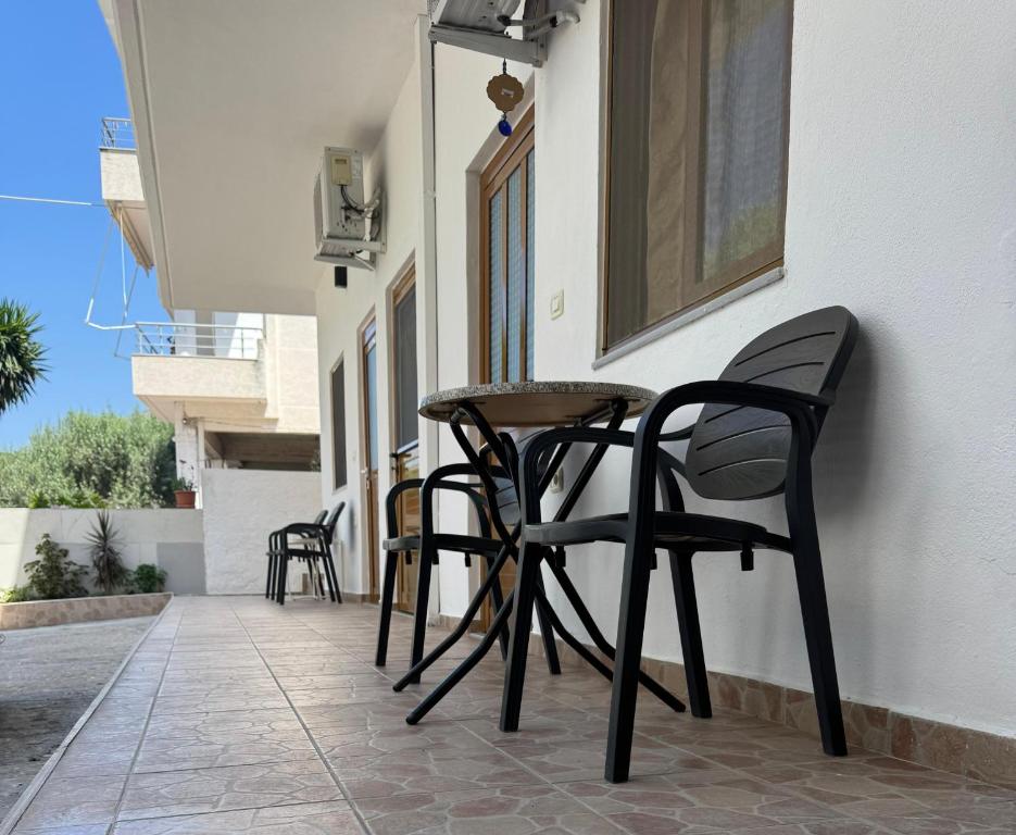 a table and chairs sitting on the side of a building at Hotel Barjami in Sarandë