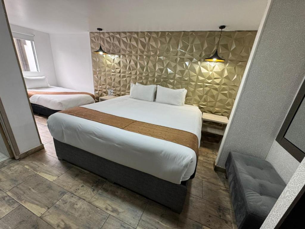 Postel nebo postele na pokoji v ubytování Hotel American Visa Normandia