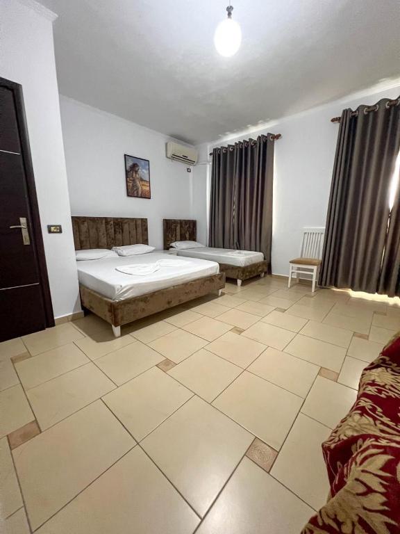 Postel nebo postele na pokoji v ubytování Hotel Rixhi