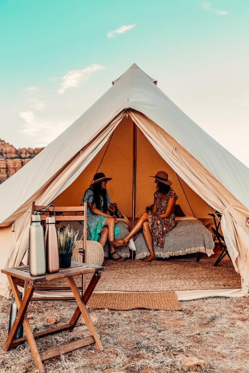 a group of three people sitting in a tent at Starlight Glamping Grand Canyon in Valle