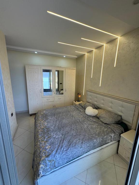 a bedroom with a large bed with two pillows at Apparemment Al Hoceïma in Al Hoceïma