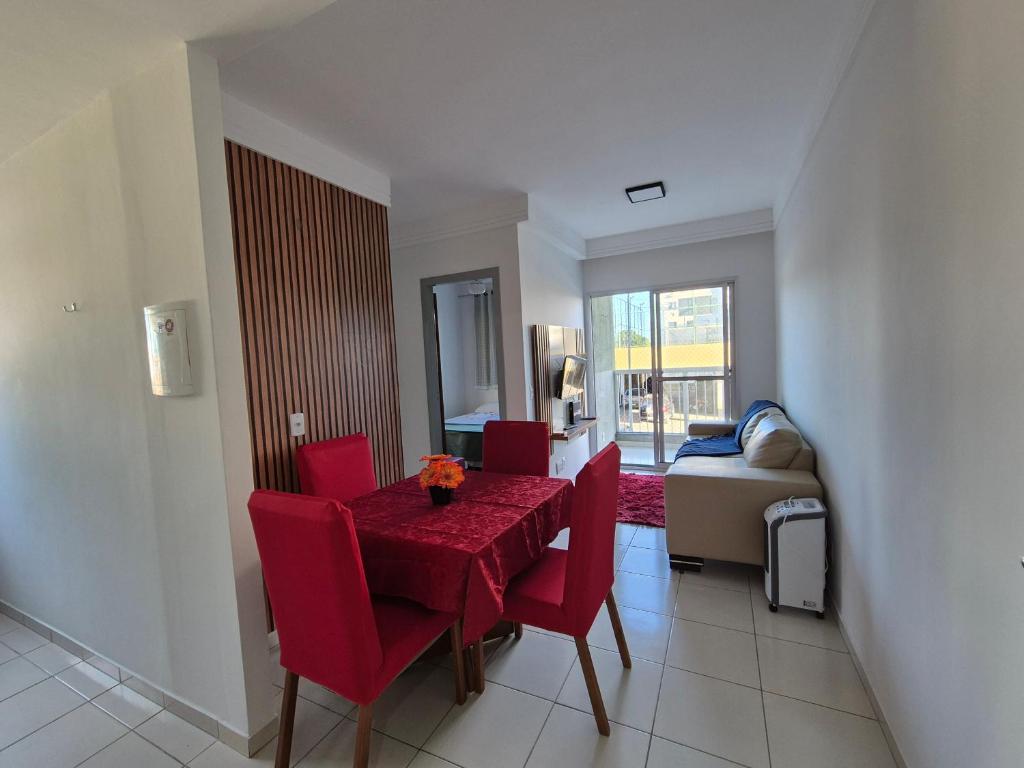 a dining room with a red table and chairs at 205 Vista do atlântico in Serra
