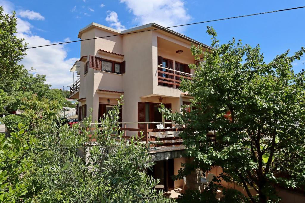 a house with trees in front of it at Apartments with parking space Selce, Crikvenica - 24450 in Selce