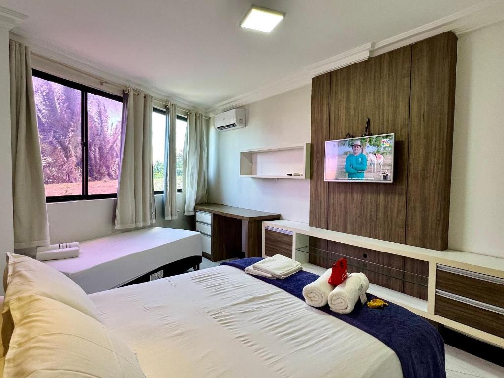 a hotel room with a bed with two stuffed animals on it at (103) Beach Garden na praia da litorânea in Pimenta