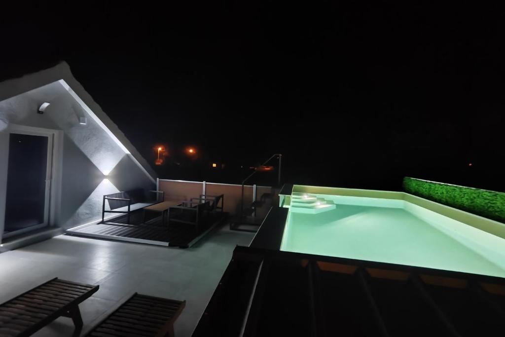 a night view of a balcony with a swimming pool at Apartments with swimming pool Bacici, Krka - 24721 in Drinovci