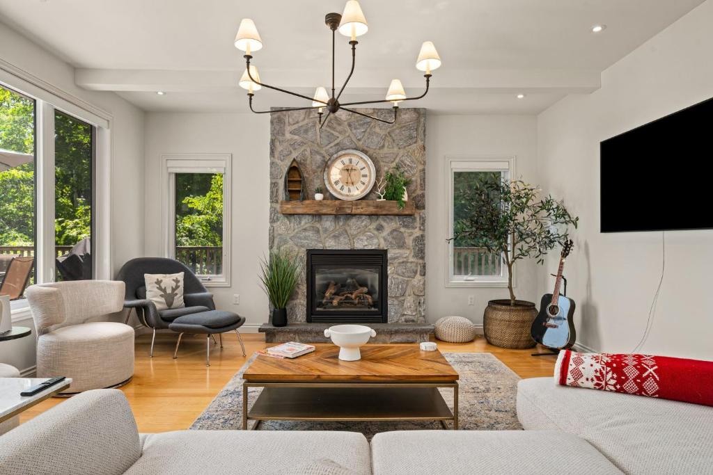 a living room with a couch and a fireplace at 1463 Big Rideau in Portland