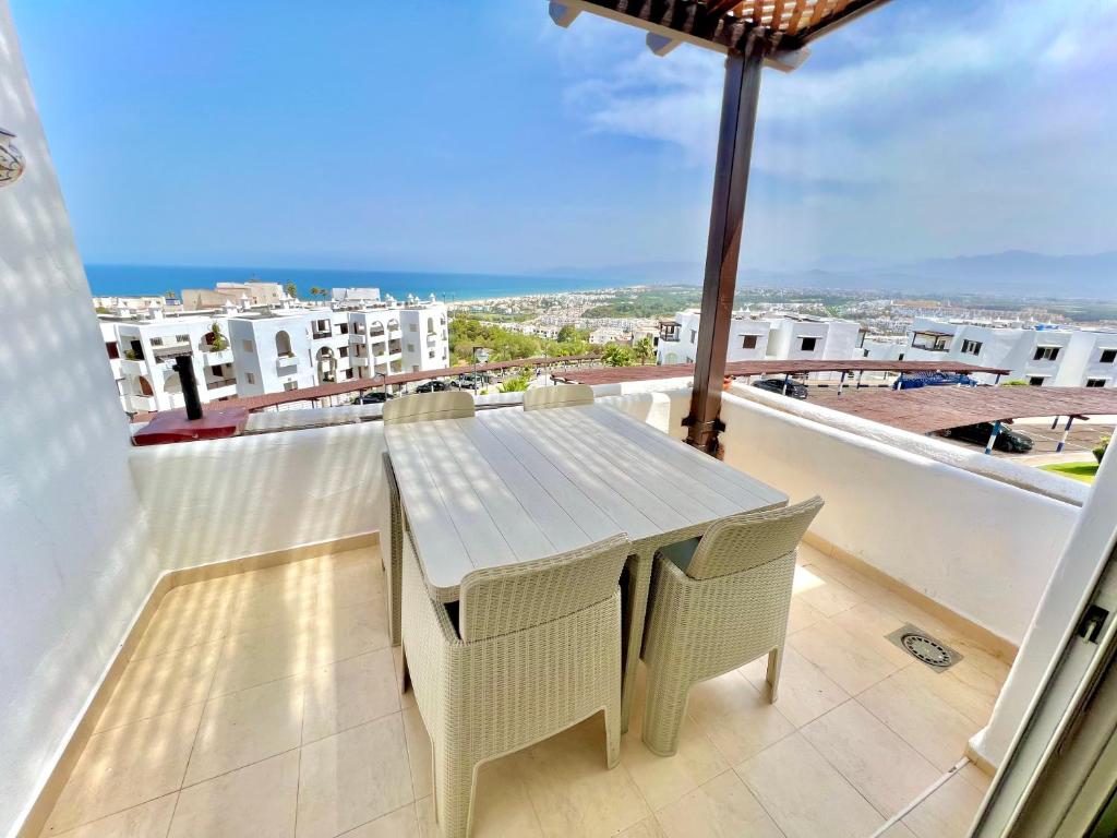 a table and chairs on a balcony with a view at Coastal Elegance - Bella Vista in Cabo Negro