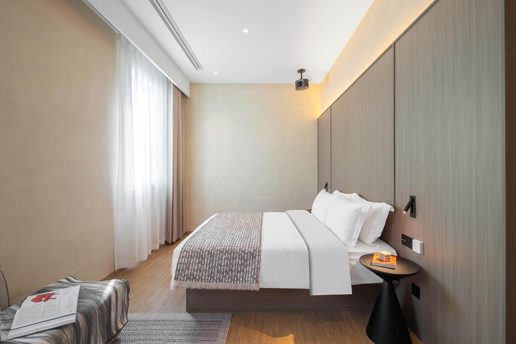 Postel nebo postele na pokoji v ubytování Mudita Hotel