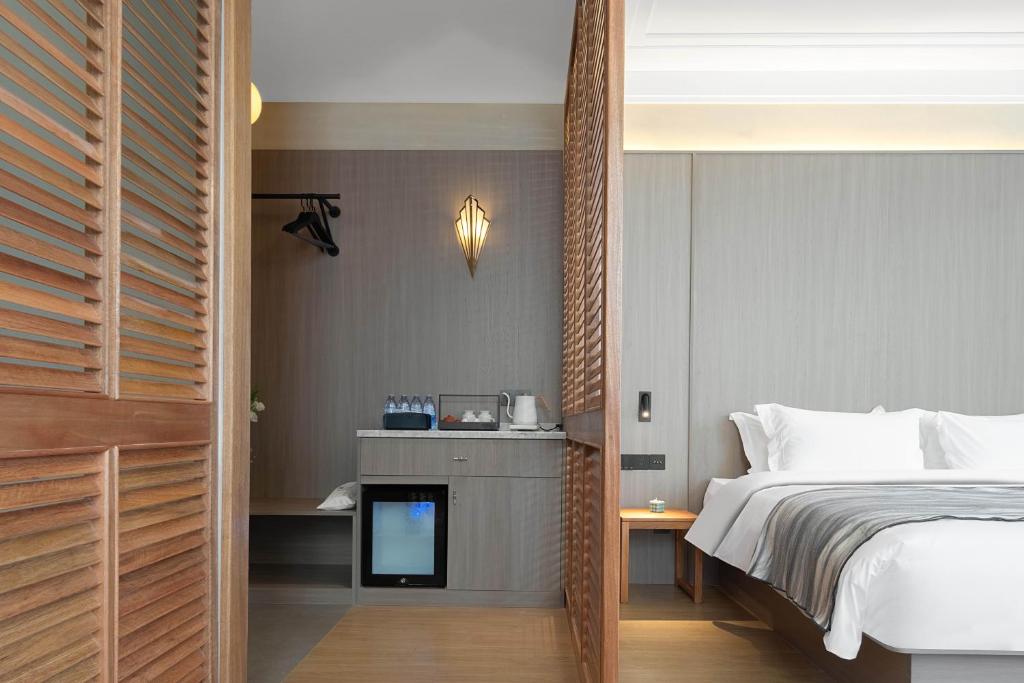 Postel nebo postele na pokoji v ubytování Mudita Hotel