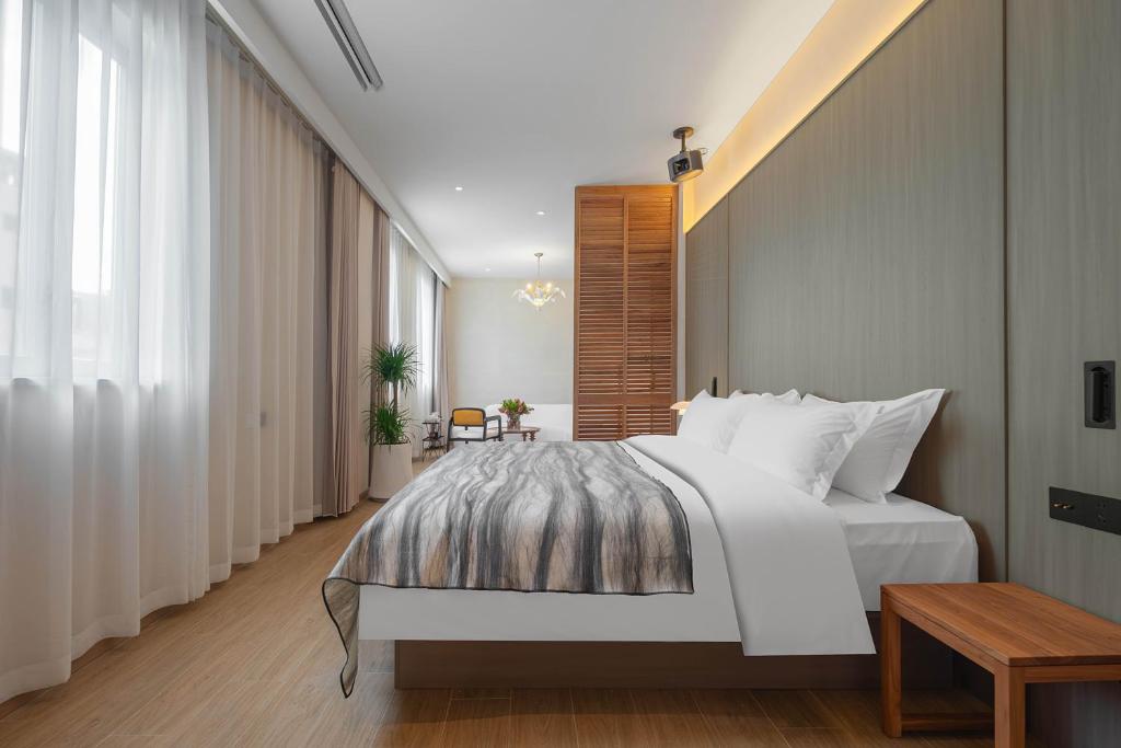 Postel nebo postele na pokoji v ubytování Mudita Hotel